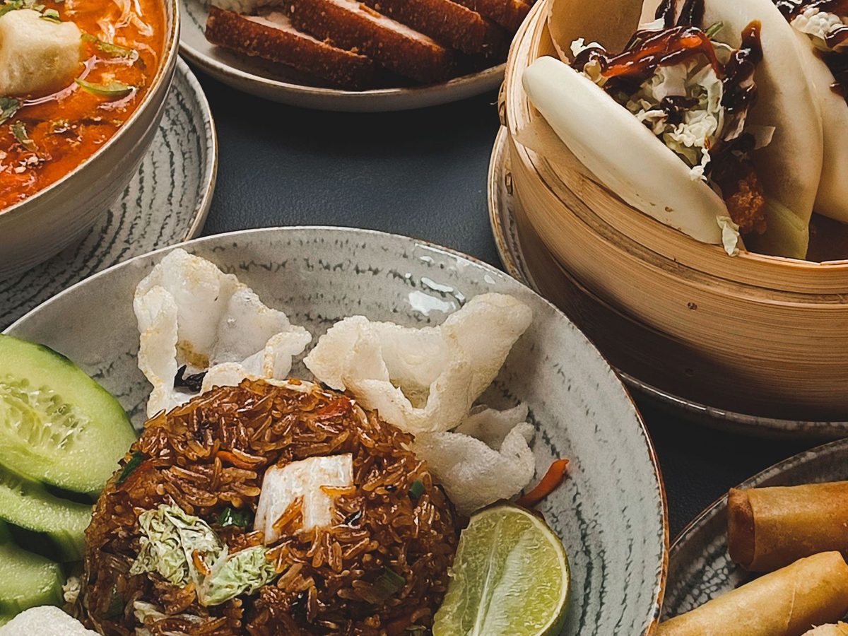 A table full of assorted Chinese dishes — dim sum, spring rolls and rice