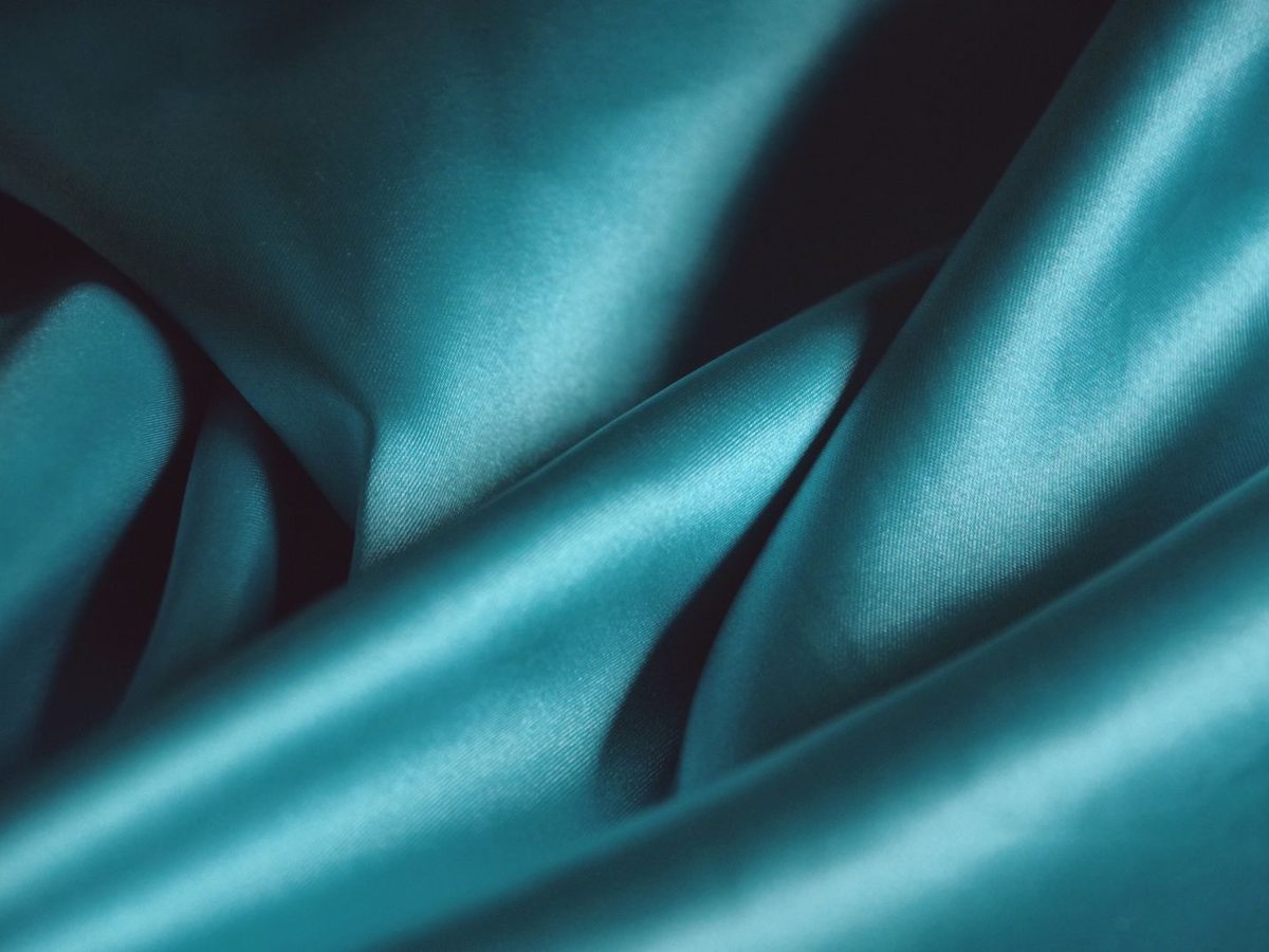 Close-up of flowing blue silk fabric catching the light