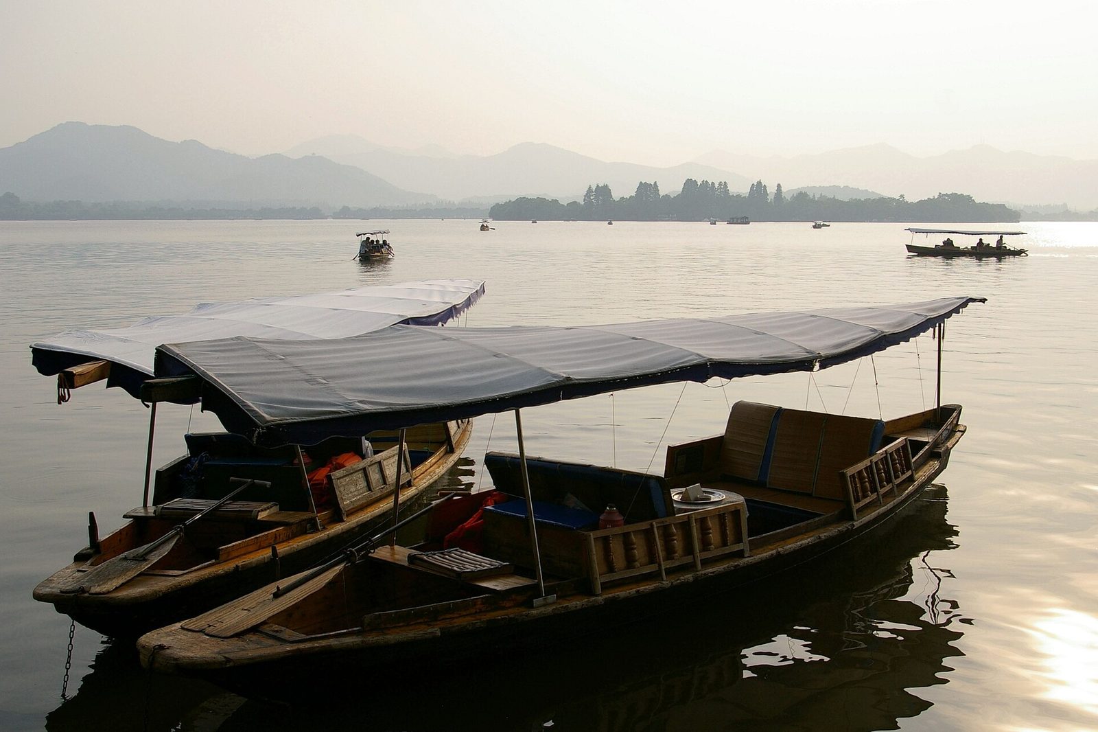 West Lake in Hangzhou with traditional covered boats on calm water