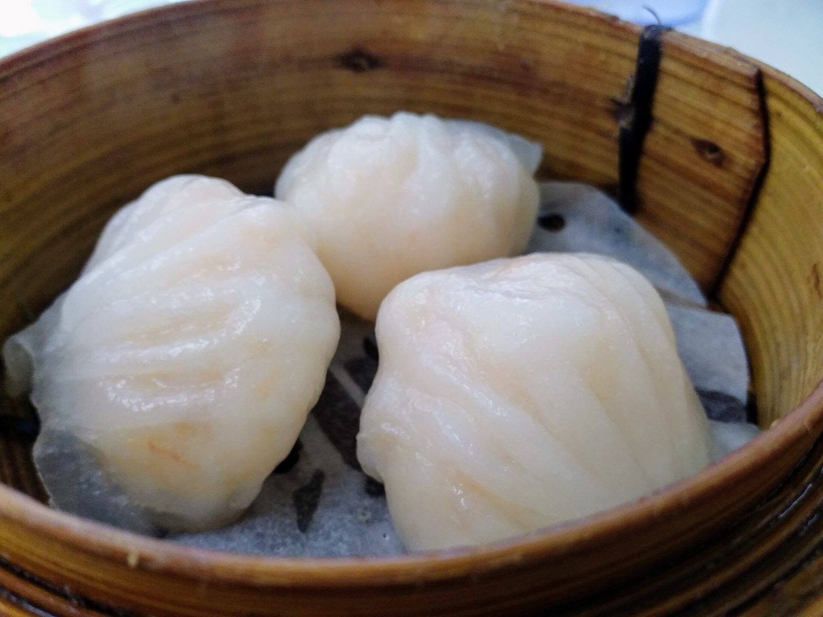 Har gow shrimp dumplings in a bamboo steamer — classic Cantonese dim sum