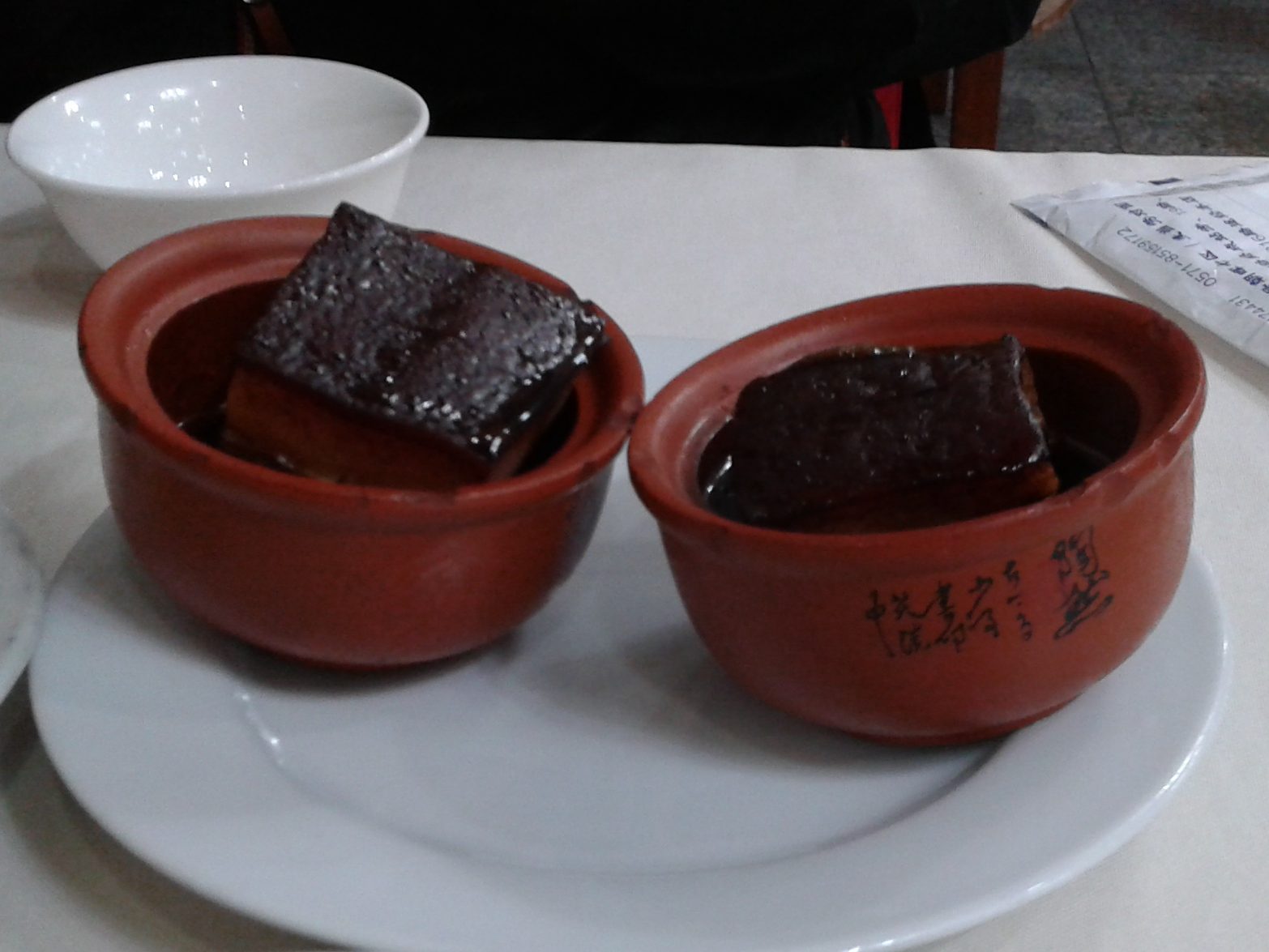 Dongpo pork — glossy braised pork belly served in small clay pots
