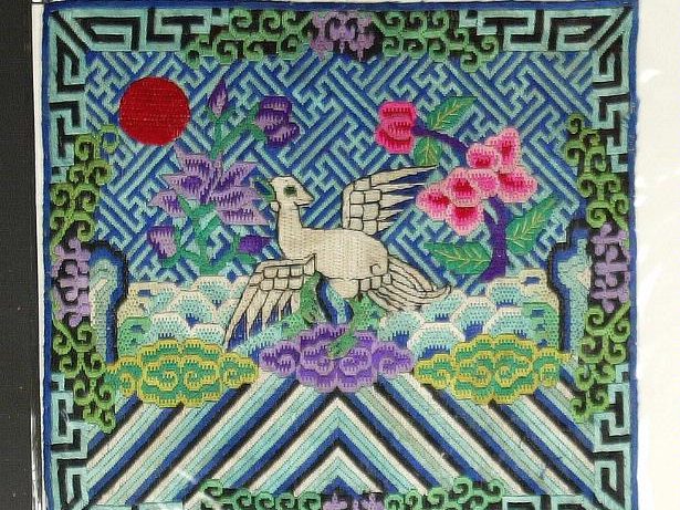 Detail of Chinese silk embroidery: a bird among peonies in fine silk thread