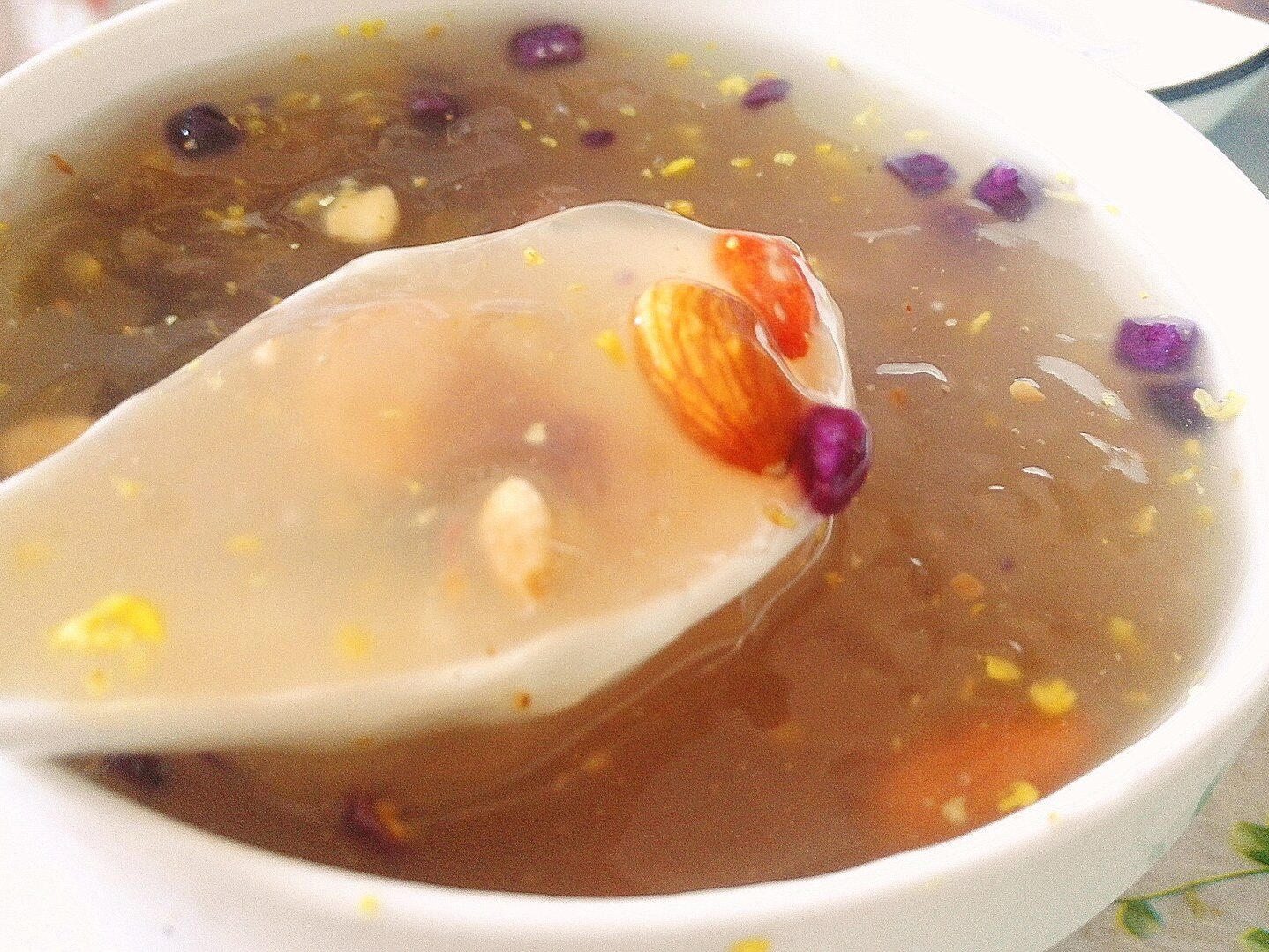 Bowl of prepared lotus root powder drink — translucent sweet soup with osmanthus and nuts