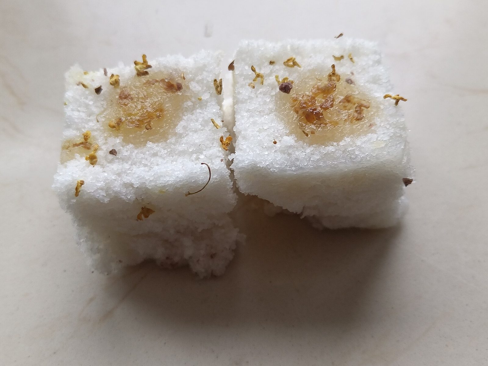 White osmanthus rice cakes — traditional Chinese pastries topped with dried osmanthus flowers